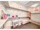 A spacious walk-in closet with shelving, ottoman and carpet flooring at 1727 Sonoran Bluff Ave, Henderson, NV 89014