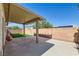 Relaxing backyard with a covered patio, lush green lawn, and block wall fencing at 1792 Gentle Brook St, North Las Vegas, NV 89084