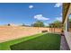 Beautiful backyard with green lawn, covered patio, and brick walls for privacy at 1792 Gentle Brook St, North Las Vegas, NV 89084