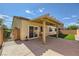 Inviting backyard featuring a covered patio, well-maintained lawn, and secure block wall at 1792 Gentle Brook St, North Las Vegas, NV 89084