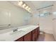 Well-lit bathroom featuring a spacious countertop, large mirror, and combined shower and bathtub at 1792 Gentle Brook St, North Las Vegas, NV 89084