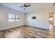 Neutral bedroom with hardwood floors, ceiling fan, and natural light from the window at 1792 Gentle Brook St, North Las Vegas, NV 89084