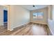 Bright bedroom with hardwood floors, ceiling fan, window, and neutral walls at 1792 Gentle Brook St, North Las Vegas, NV 89084