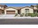 Charming single-story home featuring a well-manicured front yard and a two-car attached garage at 1792 Gentle Brook St, North Las Vegas, NV 89084