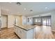 Open-concept kitchen featuring a granite island and hardwood floors and adjacent living space with sliding doors at 1792 Gentle Brook St, North Las Vegas, NV 89084