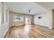 Open living room with wood flooring, natural light, and a ceiling fan at 1792 Gentle Brook St, North Las Vegas, NV 89084