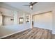 Cozy living room featuring hardwood floors, ceiling fan, and pass-through to kitchen at 1792 Gentle Brook St, North Las Vegas, NV 89084