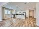 Open-concept living space with hardwood floors, a kitchen island, and bright, natural light at 1792 Gentle Brook St, North Las Vegas, NV 89084
