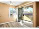 Bright bedroom featuring wood floors, large windows, and access to a private balcony at 2101 Sealion Dr # 108, Las Vegas, NV 89128