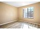 A light filled bedroom with wood-look flooring and a large picture window at 2101 Sealion Dr # 108, Las Vegas, NV 89128