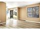 Open-concept living room with wood floors and a sliding door to a balcony at 2101 Sealion Dr # 108, Las Vegas, NV 89128