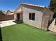 Backyard featuring a patio, artificial turf, and a block wall fence for privacy at 2105 Kendall Hill Ave, Las Vegas, NV 89106
