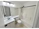 Clean bathroom with tiled shower/tub, vanity with sink and white cabinets, and black hardware at 2105 Kendall Hill Ave, Las Vegas, NV 89106