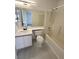 Bright bathroom featuring a tub/shower combo and a vanity with a sink and white cabinets for storage at 2105 Kendall Hill Ave, Las Vegas, NV 89106