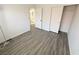 Bright bedroom features hardwood floors, neutral walls, and a closet with mirrored sliding doors at 2105 Kendall Hill Ave, Las Vegas, NV 89106