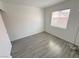 Minimalist bedroom featuring neutral walls, modern flooring, and a window for natural light at 2105 Kendall Hill Ave, Las Vegas, NV 89106
