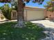 Charming single-story home featuring a well-manicured lawn and a two-car garage in a residential neighborhood at 2105 Kendall Hill Ave, Las Vegas, NV 89106