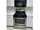 Close-up showcasing a stainless steel gas range and microwave oven in the kitchen at 2105 Kendall Hill Ave, Las Vegas, NV 89106