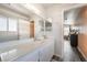 Bathroom with double mirrors and vanity, open doorway with adjacent bedroom at 2230 Wagon Ave, Pahrump, NV 89048
