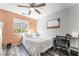 Bedroom featuring a white bed and an adjacent desk with a window at 2230 Wagon Ave, Pahrump, NV 89048