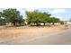Inviting single-story home featuring mature landscaping and a charming wooden fence at 2230 Wagon Ave, Pahrump, NV 89048