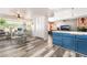 Open-concept kitchen flows into a dining area, featuring built-in cabinets and sleek flooring at 2230 Wagon Ave, Pahrump, NV 89048