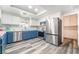 Bright kitchen features stainless steel appliances, two-toned cabinetry, and modern flooring at 2230 Wagon Ave, Pahrump, NV 89048