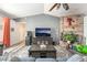 Cozy living room with a brick fireplace, ceiling fan, and wood-look flooring at 2230 Wagon Ave, Pahrump, NV 89048