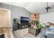Cozy living room featuring a brick fireplace, ceiling fan, and wood-style flooring at 2230 Wagon Ave, Pahrump, NV 89048