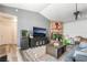 Cozy living room featuring a brick fireplace, ceiling fan, and wood-style flooring at 2230 Wagon Ave, Pahrump, NV 89048