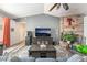 Cozy living room with a brick fireplace, ceiling fan, and wood-look flooring at 2230 Wagon Ave, Pahrump, NV 89048