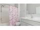 Bathroom featuring white vanity, a mirror, white countertop, and a shower with a pink floral shower curtain at 2305 W Horizon Ridge Pkwy # 524, Henderson, NV 89052