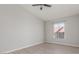 This bedroom features a ceiling fan with lights, a window with blinds, and light gray laminate flooring at 2305 W Horizon Ridge Pkwy # 524, Henderson, NV 89052
