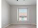This bedroom features a window with blinds, light gray walls, and light gray laminate flooring at 2305 W Horizon Ridge Pkwy # 524, Henderson, NV 89052