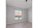 Serene bedroom with neutral walls, wood-style floors, and a window providing natural light at 2305 W Horizon Ridge Pkwy # 524, Henderson, NV 89052