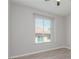 Light-filled bedroom featuring a large window with horizontal blinds and light gray laminate flooring at 2305 W Horizon Ridge Pkwy # 524, Henderson, NV 89052