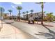 Mission Hills community entrance featuring lush landscaping, mature palm trees, and well-maintained apartment buildings at 2305 W Horizon Ridge Pkwy # 524, Henderson, NV 89052