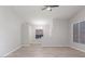 Open living room featuring sleek flooring, neutral paint, a ceiling fan, and ample natural light at 2305 W Horizon Ridge Pkwy # 524, Henderson, NV 89052