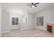 Inviting living room boasts a cozy fireplace, neutral walls, wood-look floors, and a modern ceiling fan at 2305 W Horizon Ridge Pkwy # 524, Henderson, NV 89052