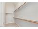 A walk-in closet featuring wooden rails for hanging clothes and a light gray laminate floor at 2305 W Horizon Ridge Pkwy # 524, Henderson, NV 89052