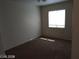 Bright bedroom with neutral walls and carpeted floor, featuring a window with natural light at 256 Camino Viejo St, Henderson, NV 89012