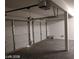 Spacious two car garage with white walls, concrete floor, and two car garage doors at 256 Camino Viejo St, Henderson, NV 89012