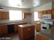 Bright kitchen featuring wood cabinetry, granite countertops, and a white microwave at 256 Camino Viejo St, Henderson, NV 89012