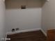 A small and simple unfinished laundry room with plain white walls and wood-look flooring at 256 Camino Viejo St, Henderson, NV 89012