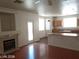 Open-concept living room with a fireplace, hardwood floors, and views into the kitchen and backyard at 256 Camino Viejo St, Henderson, NV 89012