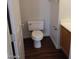 A compact toilet room with a standard toilet and wood-look flooring at 256 Camino Viejo St, Henderson, NV 89012
