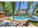 Inviting backyard oasis with pool, tiki bar, lush landscaping and ample seating at 2608 Prospector Mine Ave, North Las Vegas, NV 89031