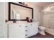 Bathroom featuring modern white vanity, large mirror, and glass shower door at 2608 Prospector Mine Ave, North Las Vegas, NV 89031
