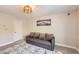 Bedroom with cozy gray sofa, neutral walls, and a window with natural light at 2608 Prospector Mine Ave, North Las Vegas, NV 89031