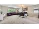 Large bedroom with a decorative light fixture, seating area, and window views at 2608 Prospector Mine Ave, North Las Vegas, NV 89031